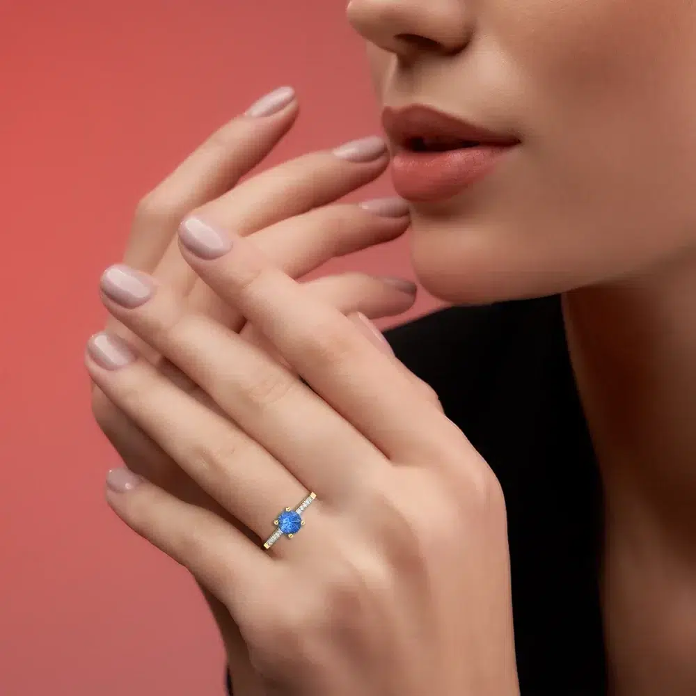 Round blue sapphire and diamond ring